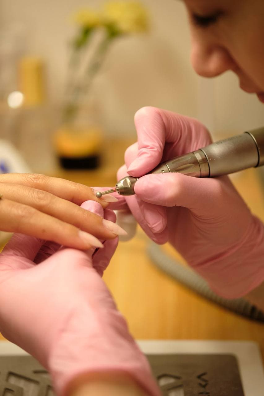 E-file nail drill close-up showing precision work